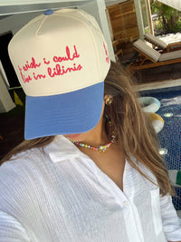 Front view of I Wish I Could Live in Bikinis blue vintage trucker hat