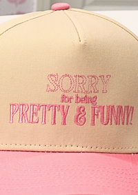 Close up of structured pink and natural baseball hat styled for casual wear
