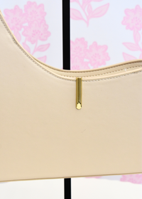 Prya cream shoulder bag featuring smooth finish and gold hardware
