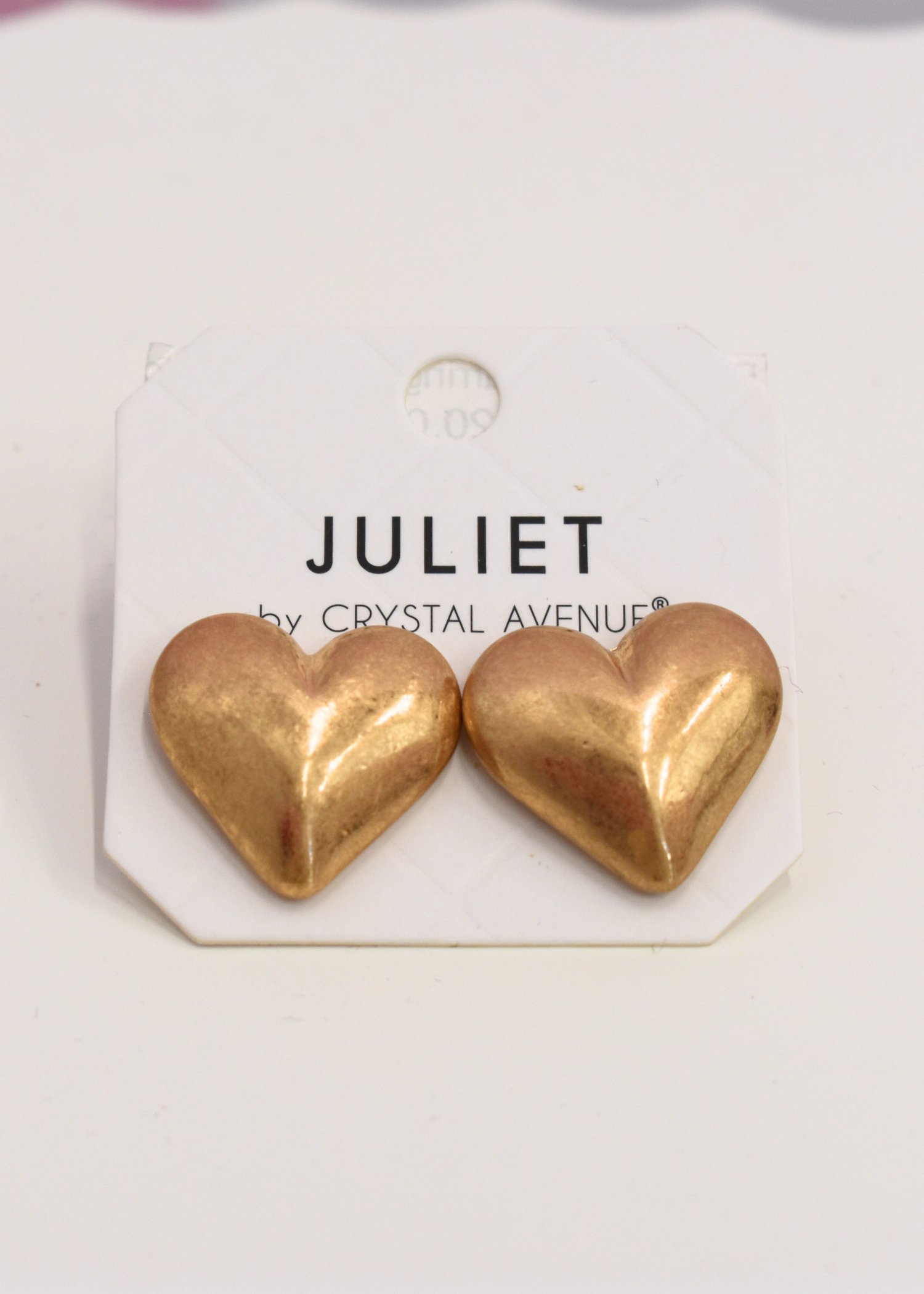 Gold puffy heart earrings featuring rounded heart design