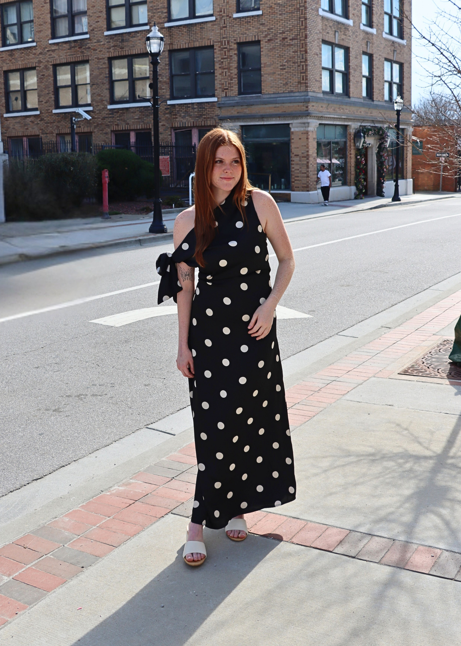 Front view of Remie black polka dot satin bias dress with draped neckline