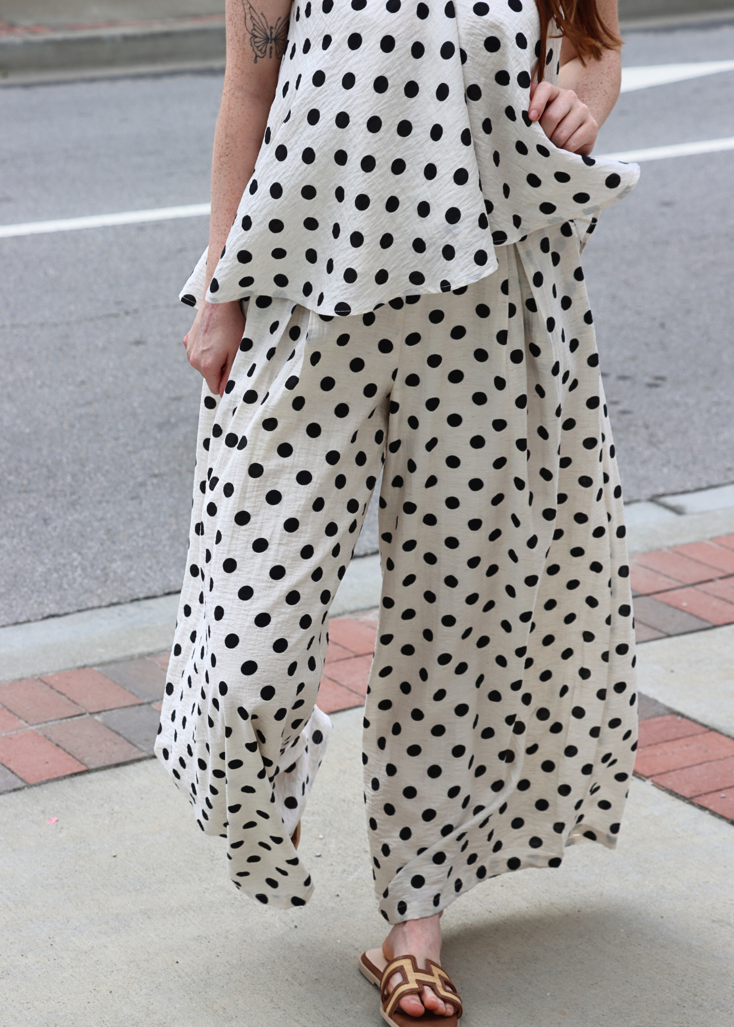 Polka dot linen pants styled as resort wear outfit