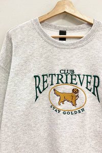 Embroidered retriever club sweatshirt hanging on hanger