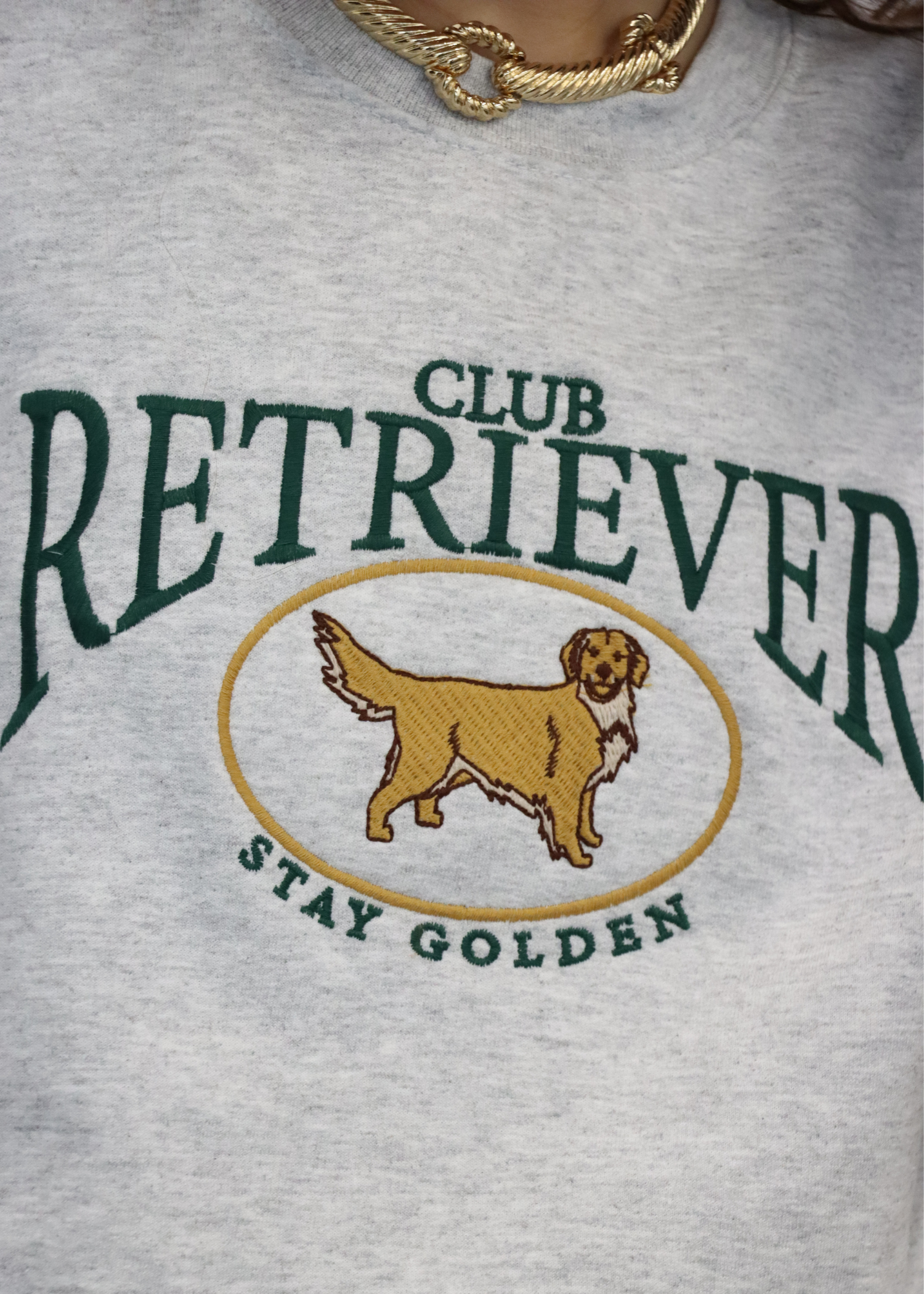 Close up of embroidered retriever graphic on sweatshirt