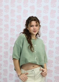 Side view of light green short sleeve knit cardigan