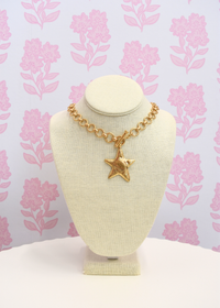 Gold star necklace styled for everyday wear