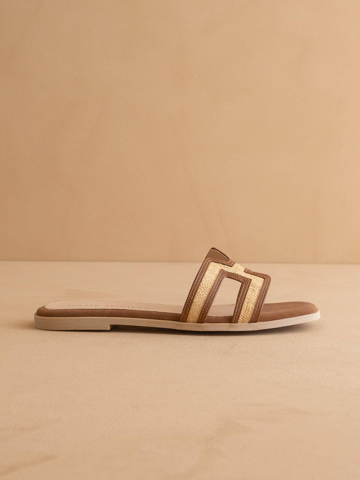 Side view of Ena raffia flat slide sandal