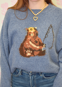 Knit sweater with bear fishing styled with wide leg jeans and trendy necklace