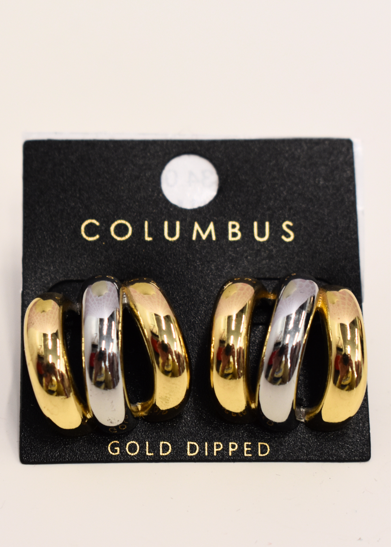 Gold and silver hoop earrings with layered design detail