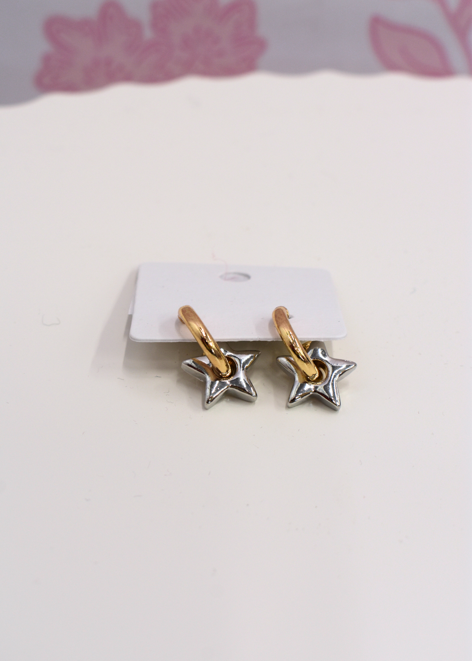 Silver and gold hoop earrings with star detail