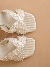White pearl raffia block heel styled for wedding guest outfit
