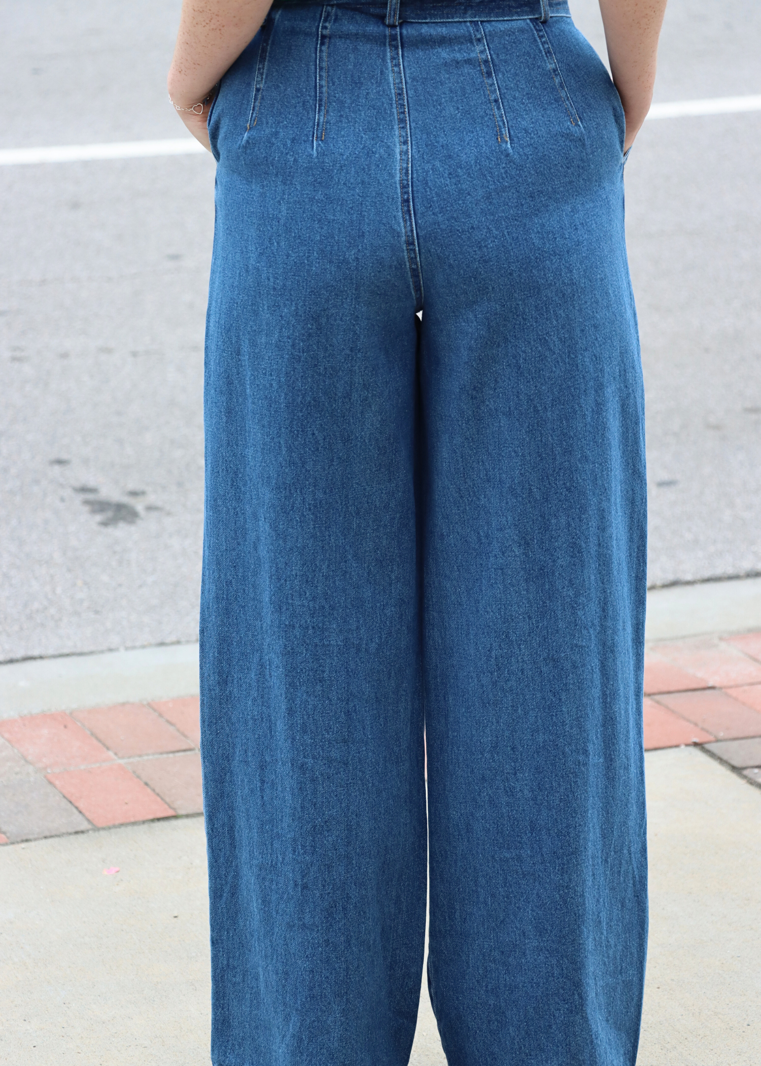 Close Up Back view of high rise wide leg dark wash denim pants