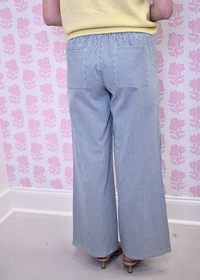White and blue pinstripe pants styled for everyday wear